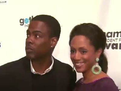 Chris Rock is on a black suit whereas, Malaak Compton-Rock is wearing a purple dress.